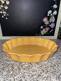 Cerruti stoneware mustard yellow oval baking dish, front view