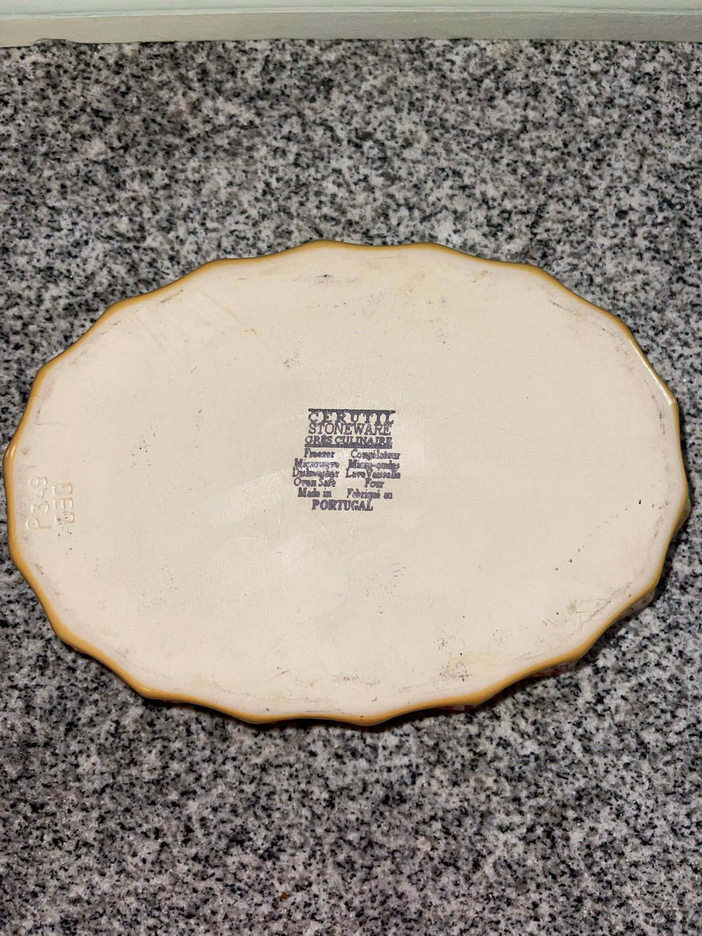 Back of Cerruti stoneware oval platter with maker's mark