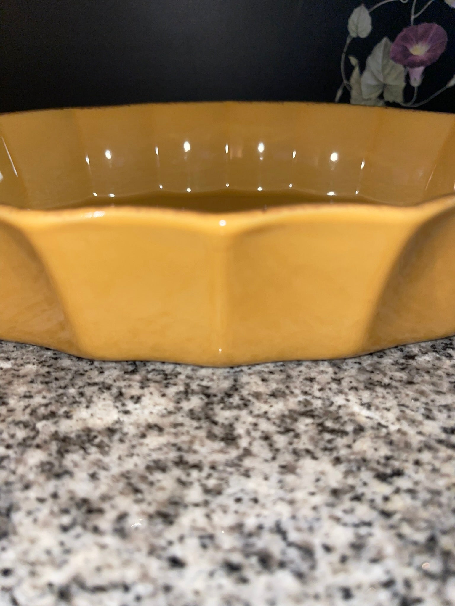 Side profile of mustard yellow stoneware baking dish