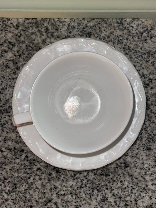 Top-down view of Gibson white embossed teacup and saucer