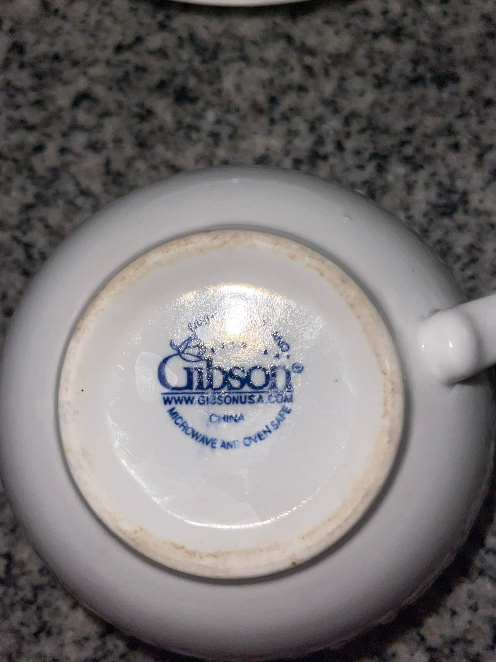Bottom of Gibson teacup showing Gibson Everyday backstamp, microwave and oven safe