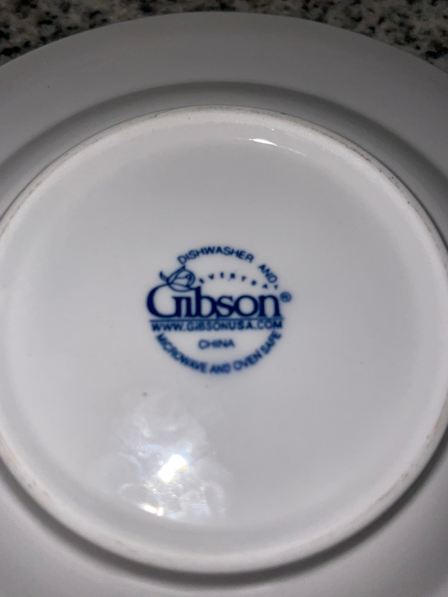 Bottom of Gibson saucer showing dishwasher, microwave and oven safe backstamp