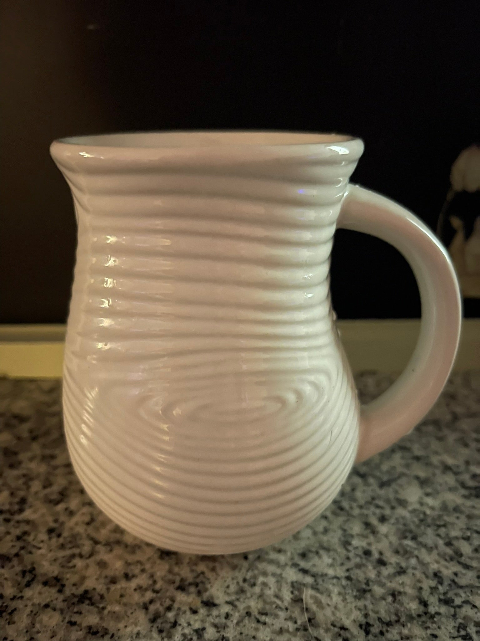 Close-up of Temp-tations white ribbed mug showing concentric ring texture