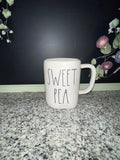 Rae Dunn SWEET PEA mug front view showing elongated font on white ceramic