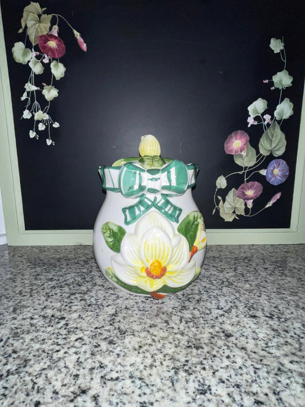 NINS 1997 magnolia cookie jar with lid, front view showing raised magnolia and teal bow