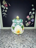 NINS 1997 magnolia cookie jar with lid, front view showing raised magnolia and teal bow