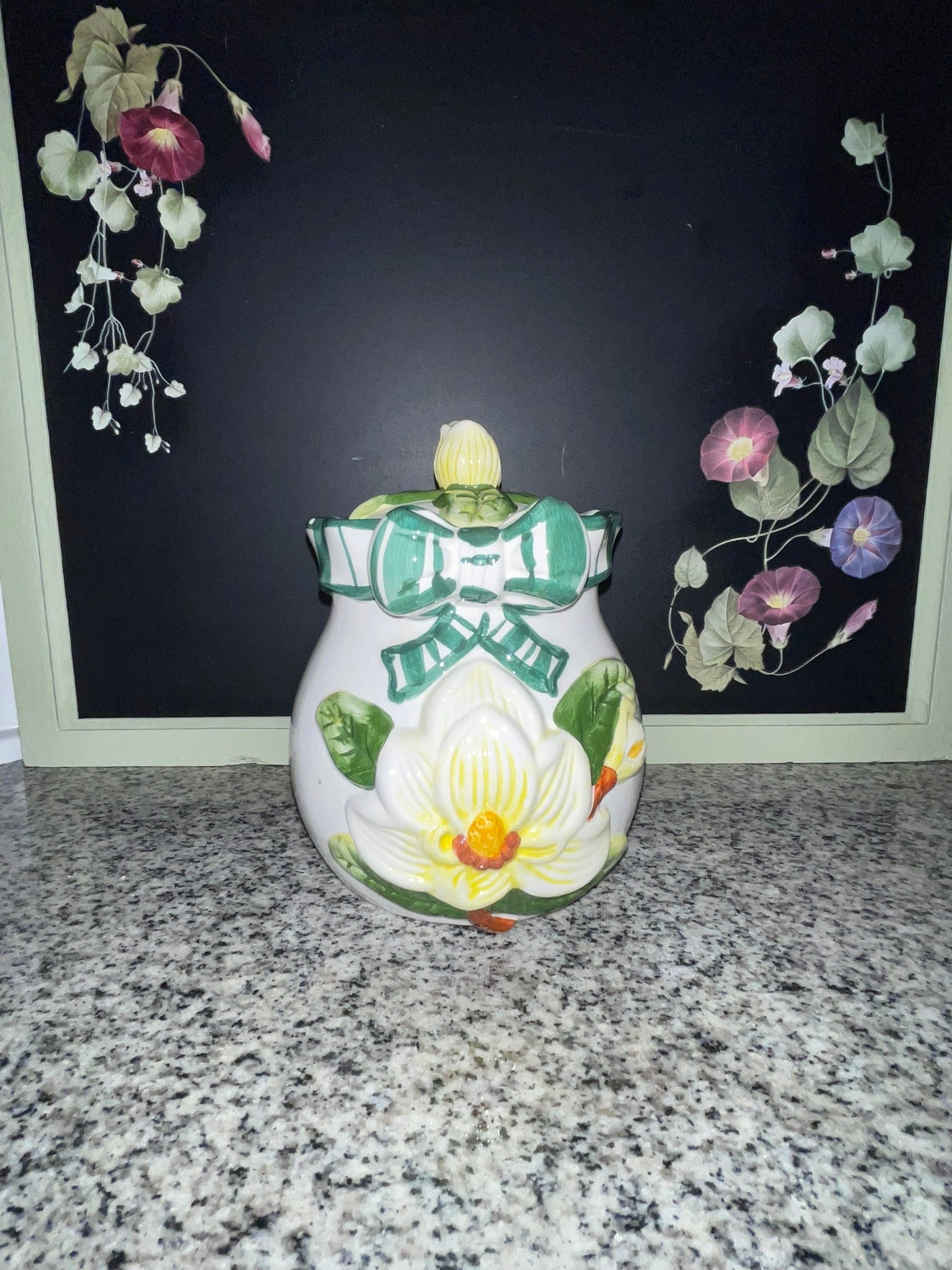 NINS 1997 magnolia cookie jar with lid, front view showing raised magnolia and teal bow
