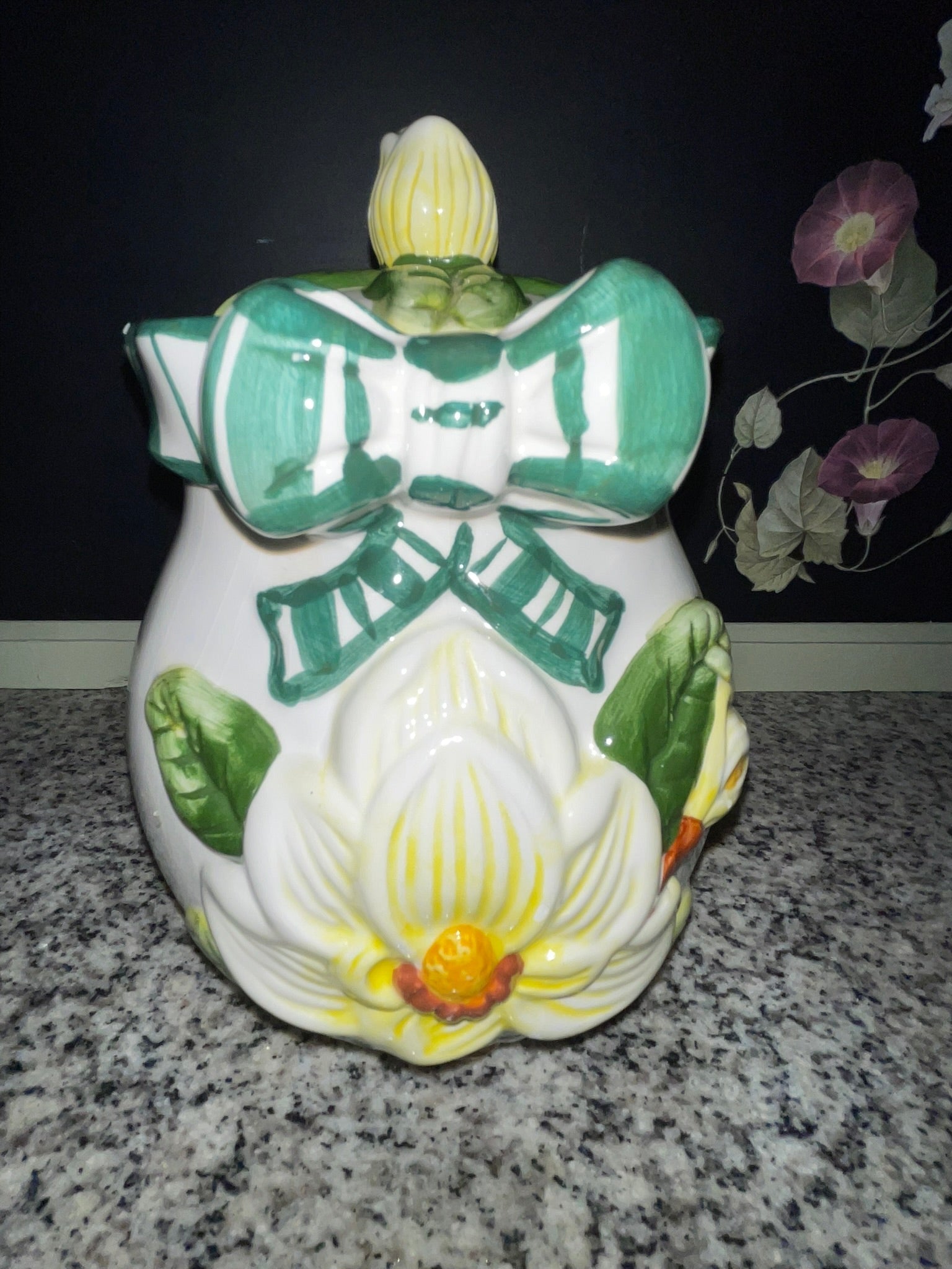 Close-up front view of NINS magnolia cookie jar showing hand-painted detail and ribbon bow