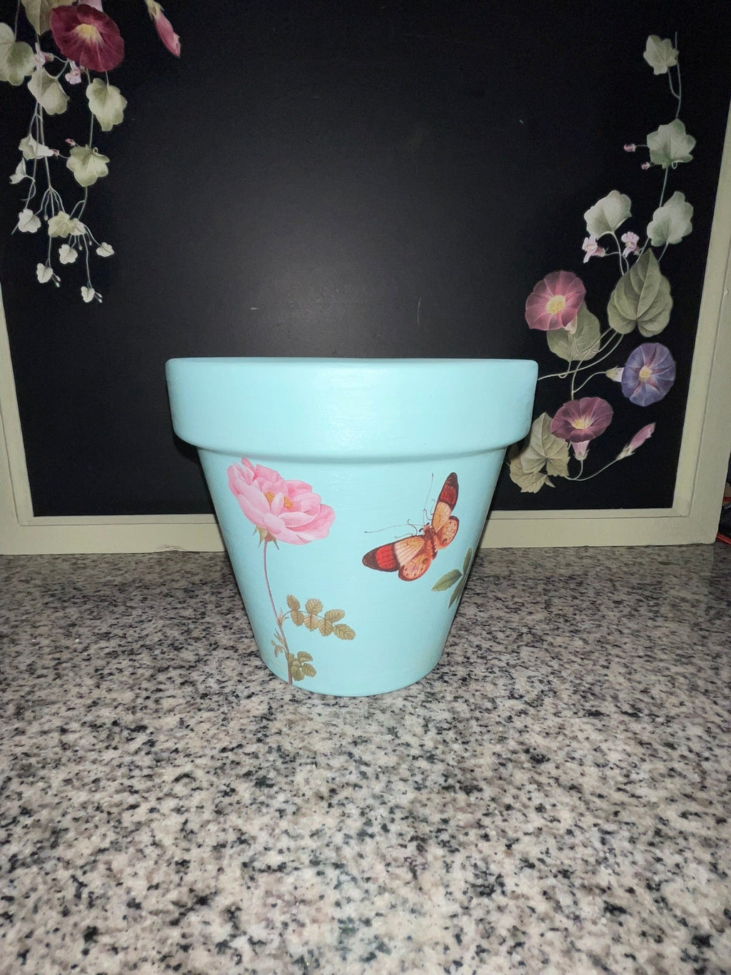 Aqua blue botanical planter showing pink rose and butterfly decoupage, front view