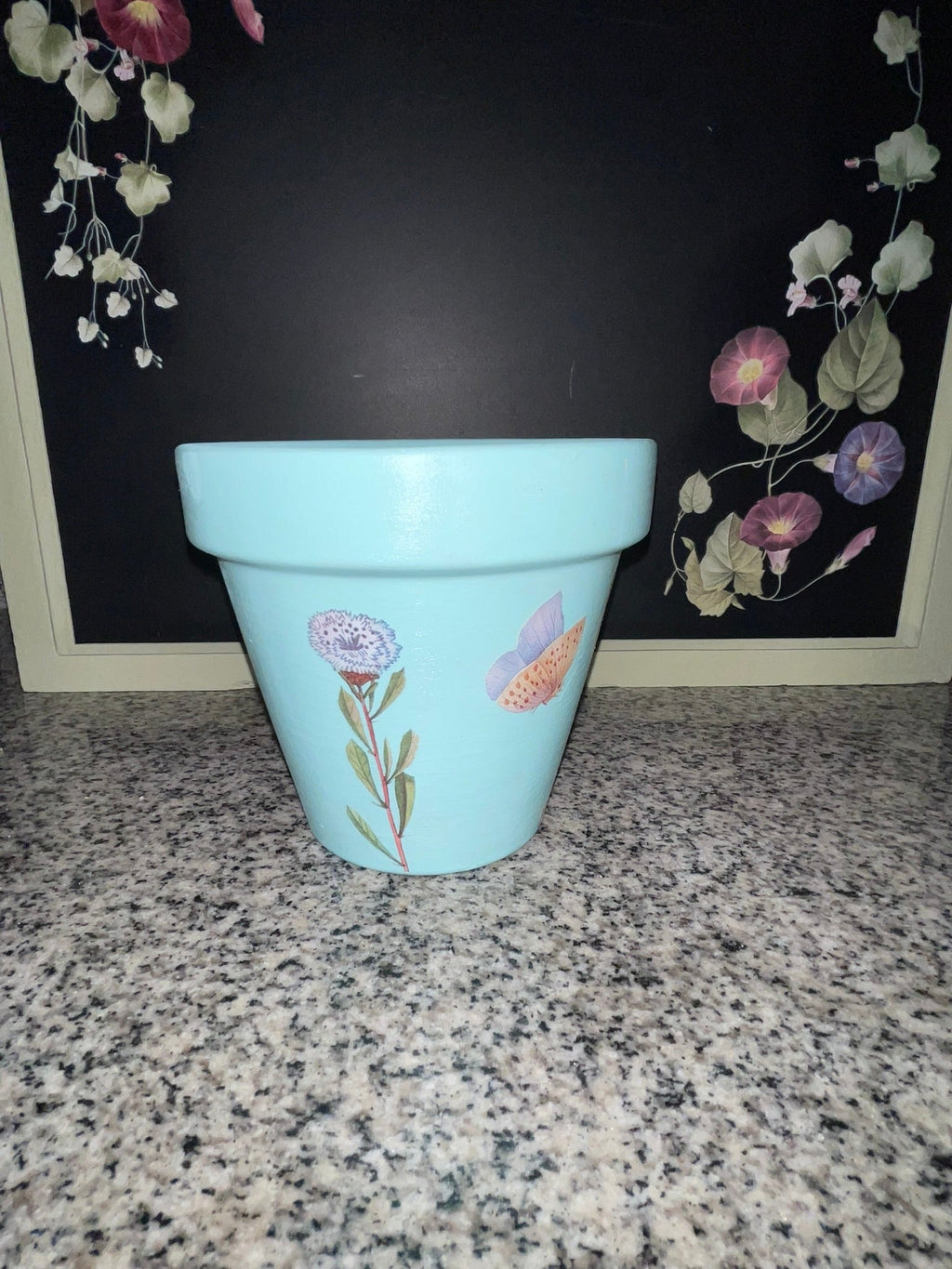 Second side of aqua blue planter showing purple wildflower and butterfly decoupage