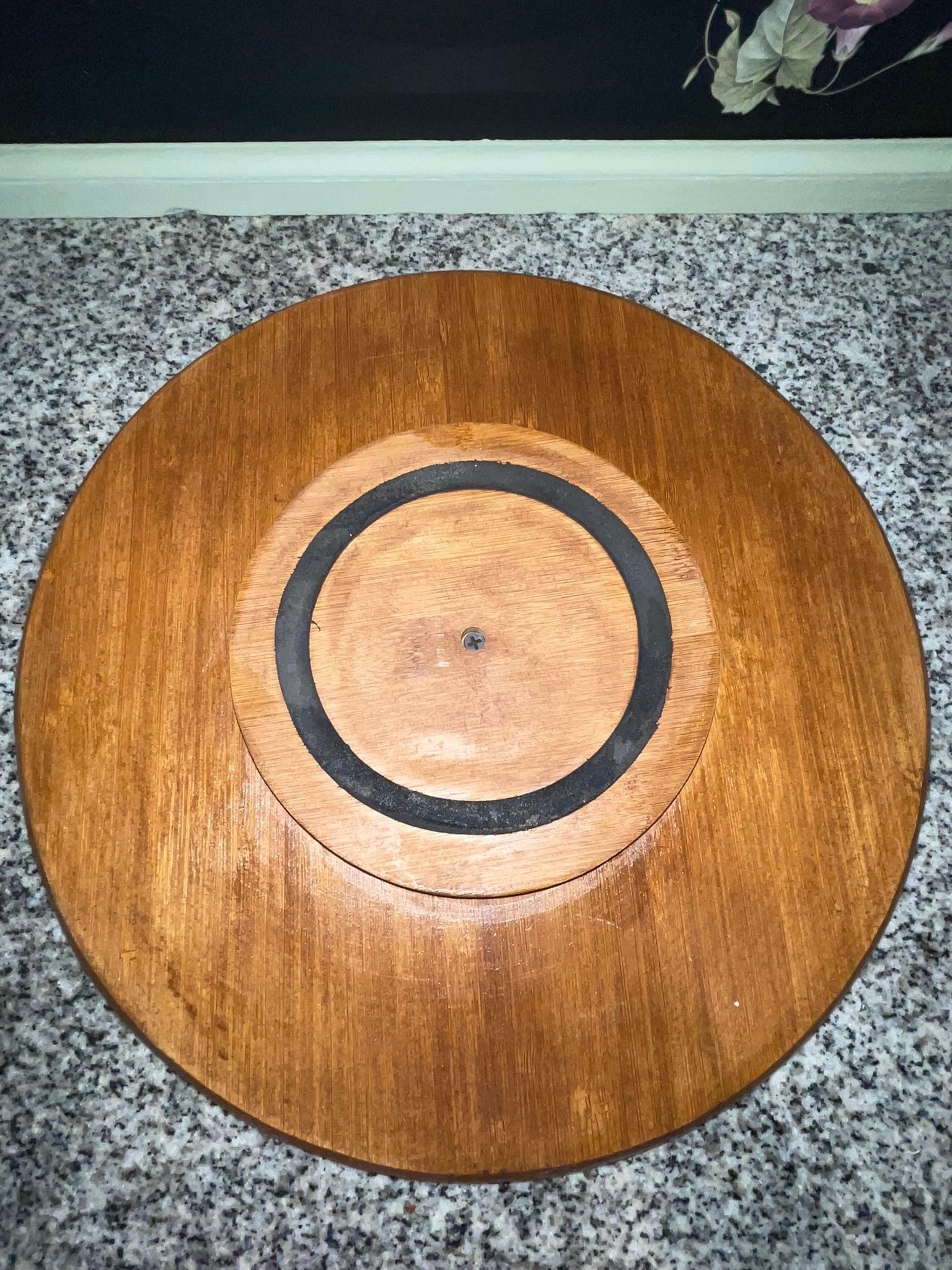Underside of vintage bamboo lazy Susan showing rubber ring spinning base and center screw