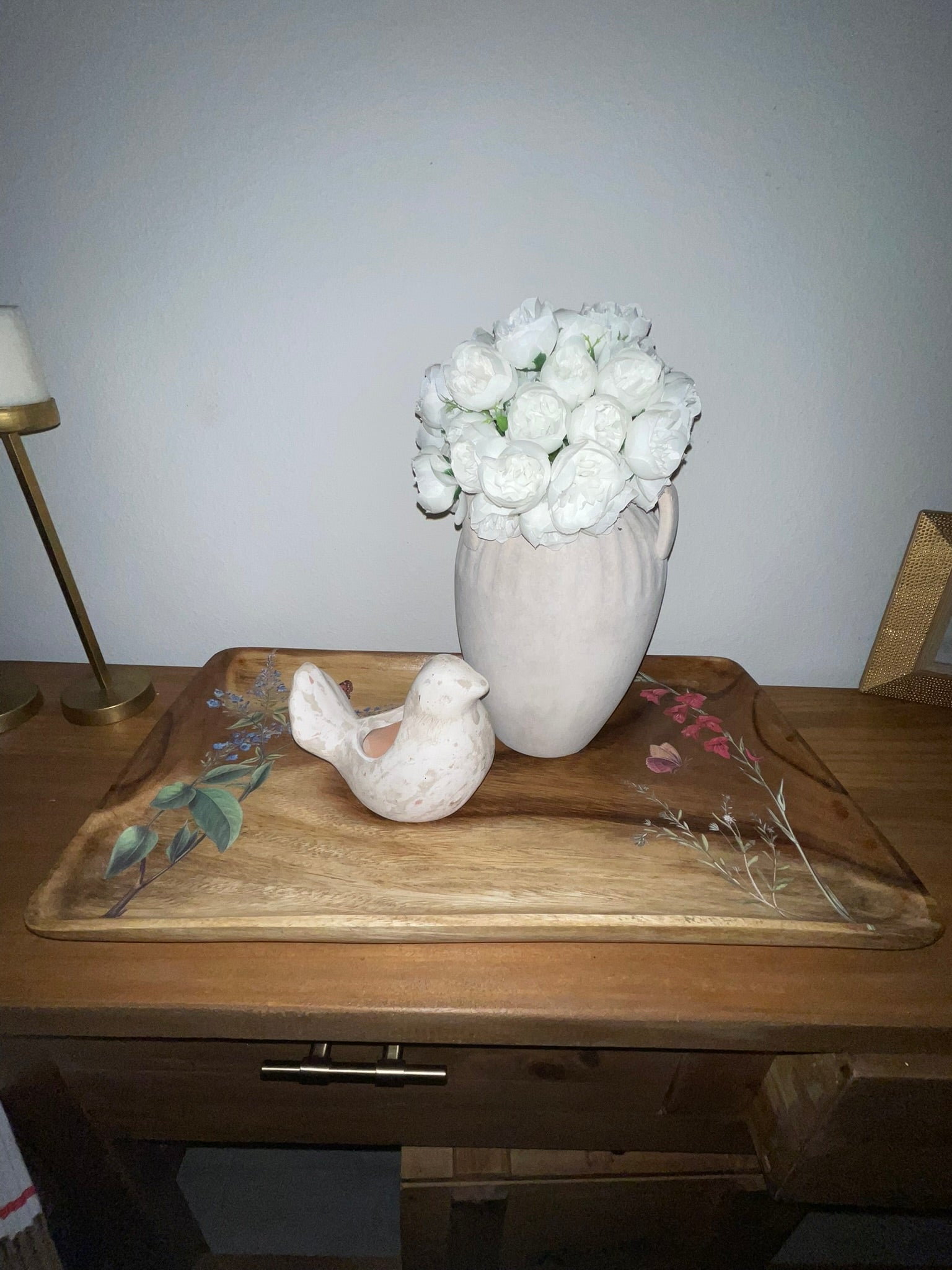 Vintage wood botanical tray styled on dresser with white ceramic vase and bird figurine