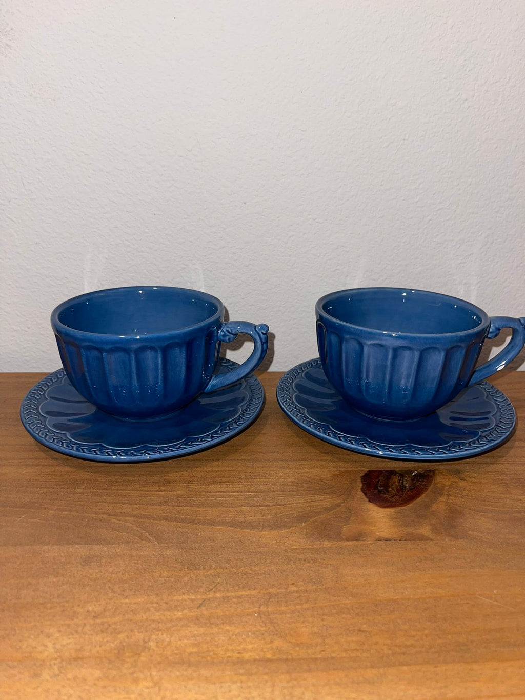 Two American Atelier Athens Blue ironstone cups and saucers side by side