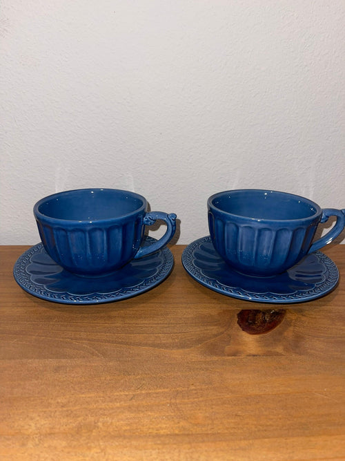 Two American Atelier Athens Blue ironstone cups and saucers side by side
