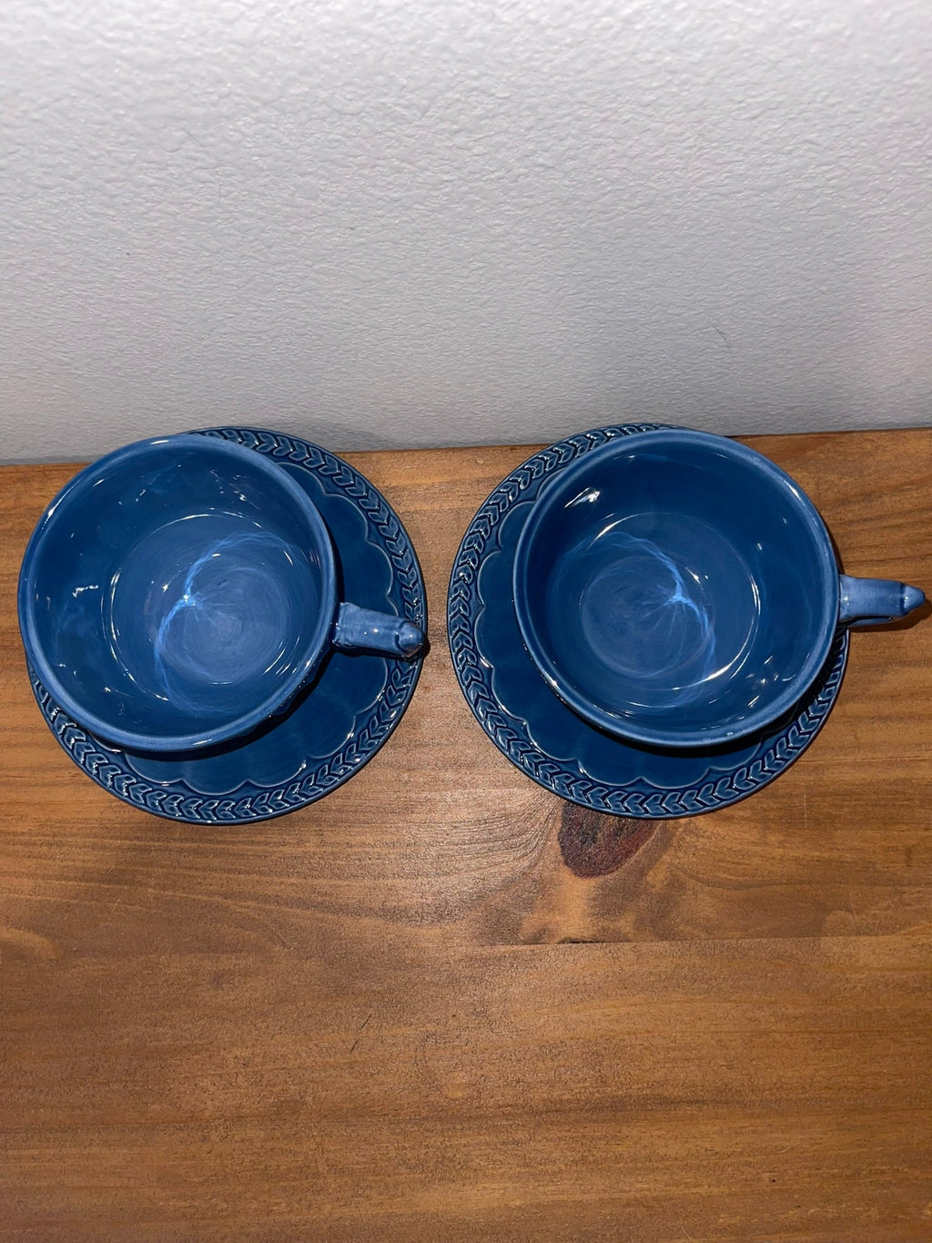 Overhead view of two Athens Blue cups and saucers showing embossed laurel border