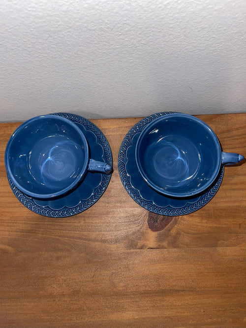 Overhead view of two Athens Blue cups and saucers showing embossed laurel border
