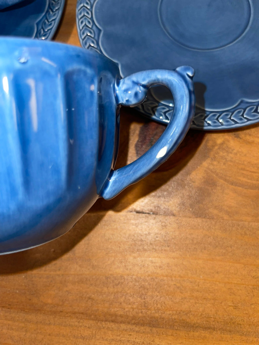 Close-up of Athens Blue cup handle showing decorative scroll detail