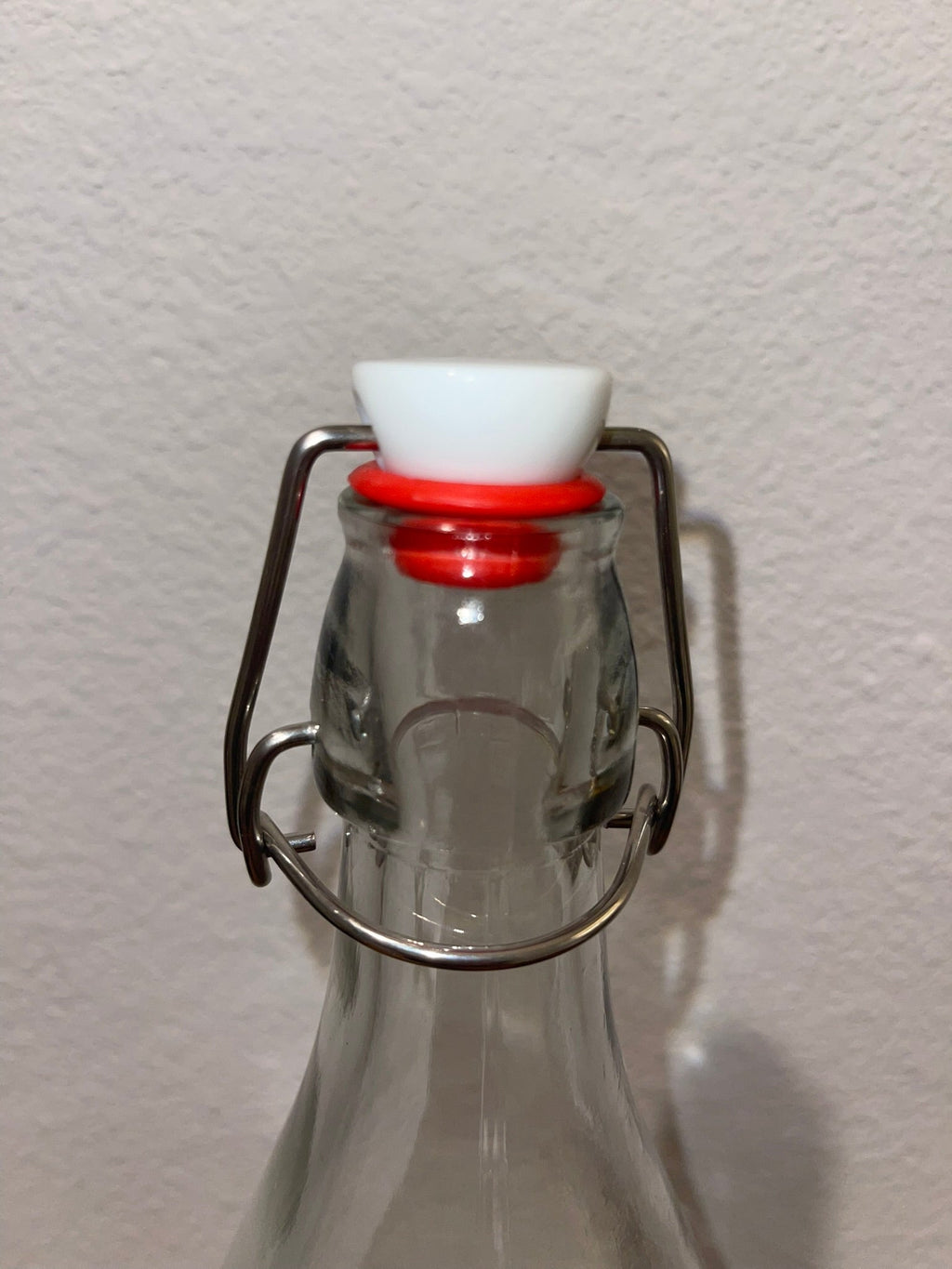 Close-up of swing-top wire bail and ceramic stopper with red gasket closed
