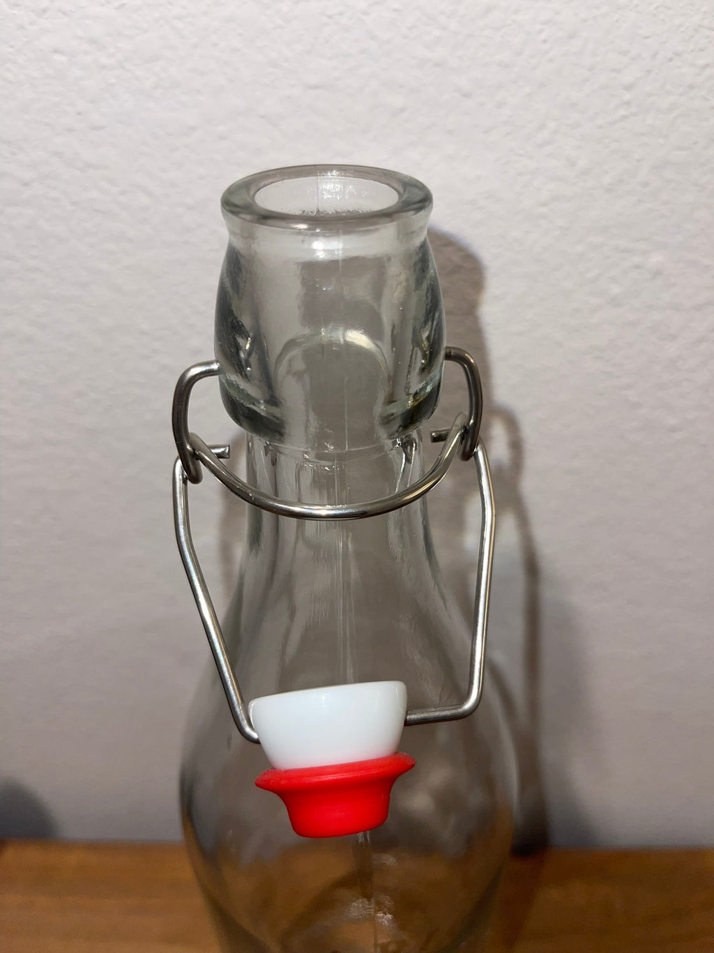 Top view of swing-top bottle with stopper open showing wire bail