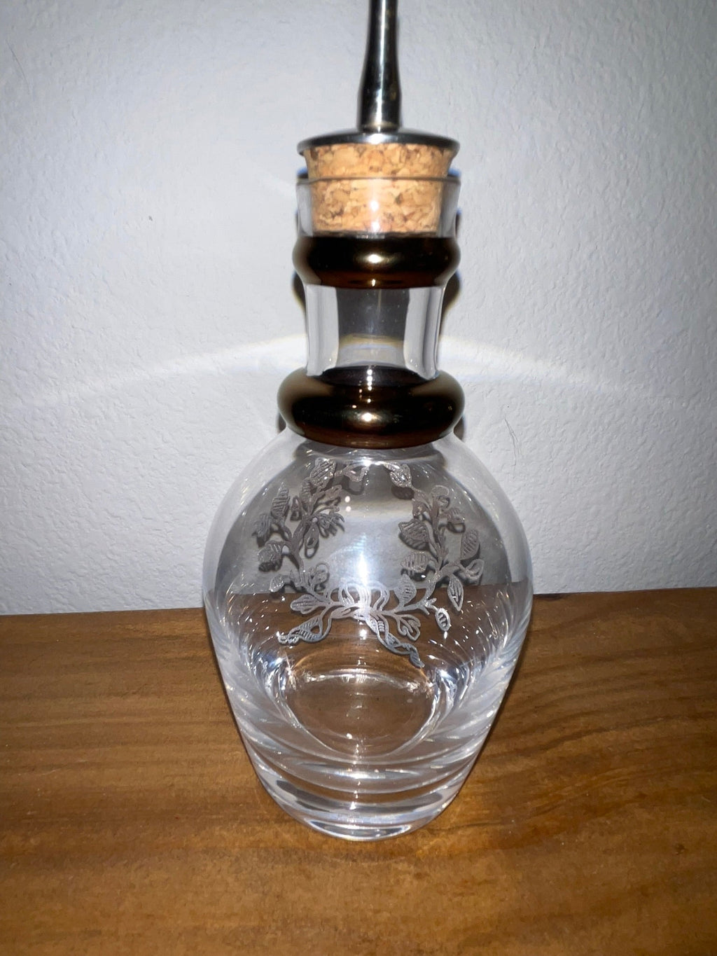 Vintage glass cruet decanter showing clear etched floral motif reverse side