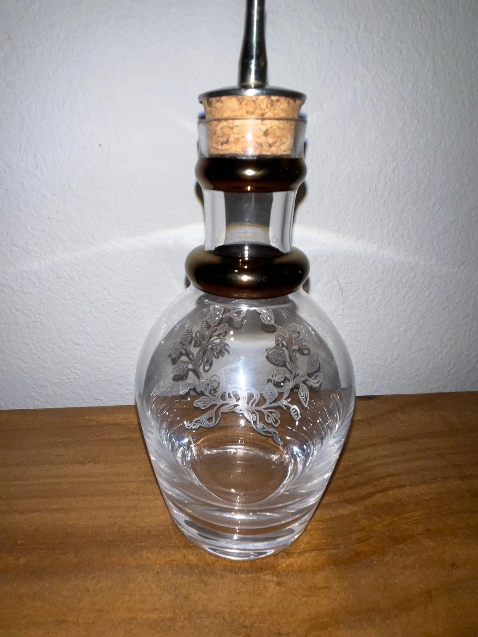 Vintage glass cruet decanter showing clear etched floral motif reverse side