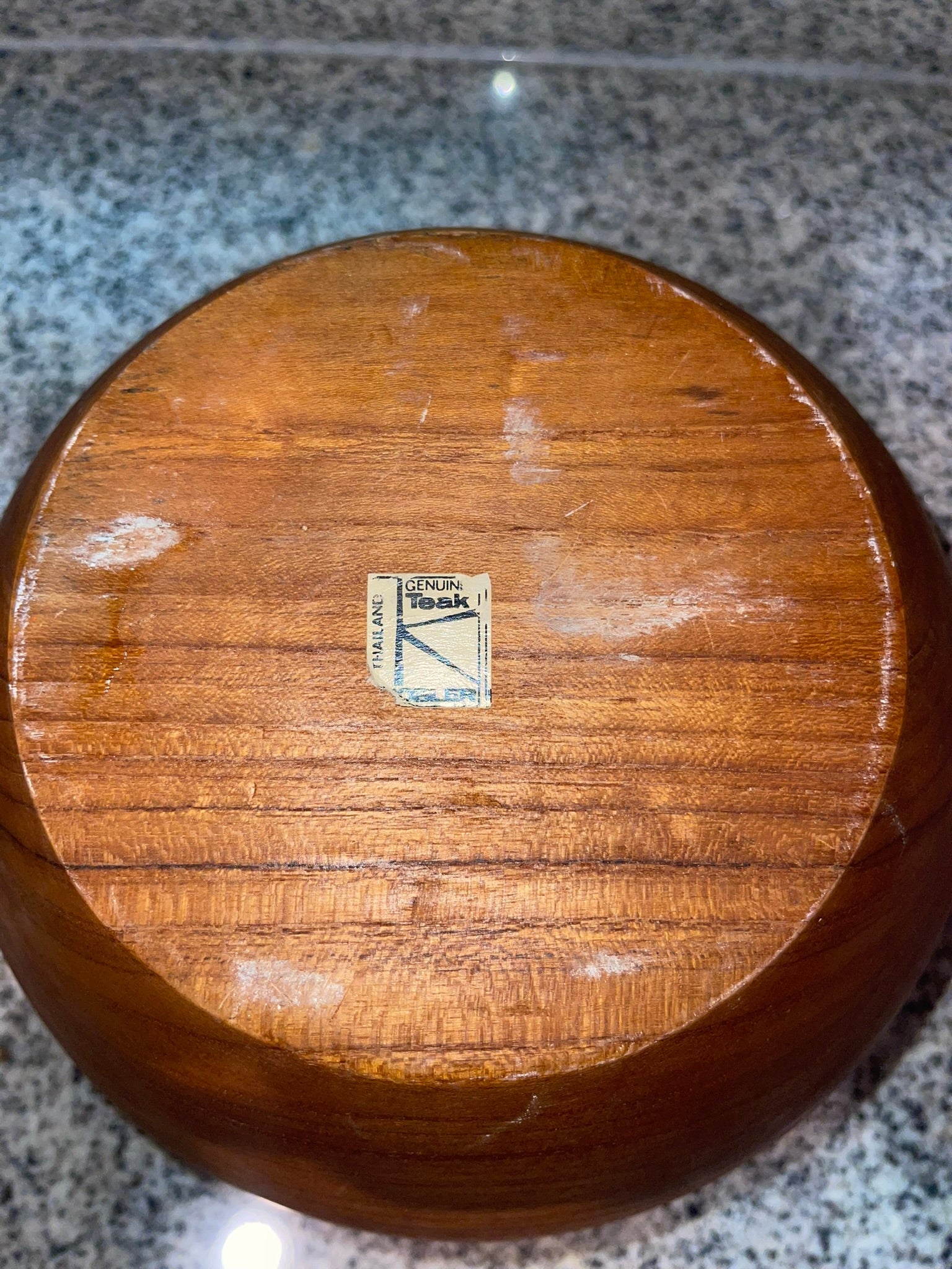 Bottom of teak bowl showing Genuine Teak Thailand label